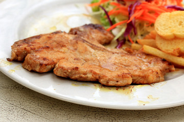 Pork chop, french fries with salad