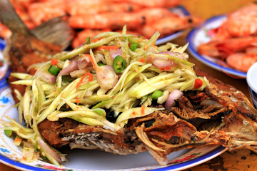 Fried fish with mango salad.