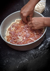 Closeup of a chicken and potato pie cooking process © yarlander