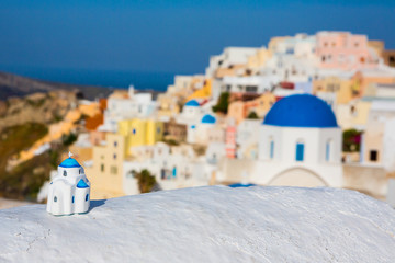 view of the Greek city of Oia with a miniature souvenir house