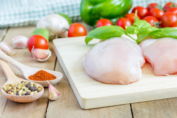 Raw chicken fillet with herbs and vegetables