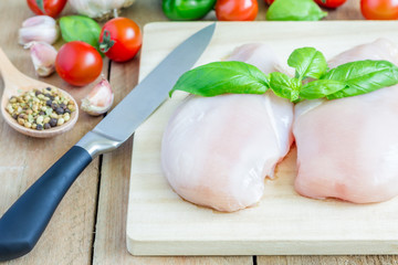 Raw chicken fillet with herbs and vegetables