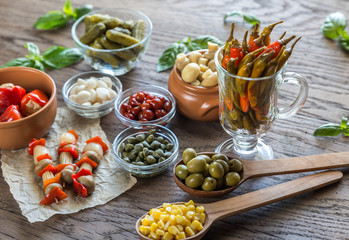 Pickled vegetables on the wooden background