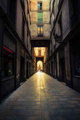 Fototapeta na wymiar Straight narrow street in Gothic quarter, Barcelona.