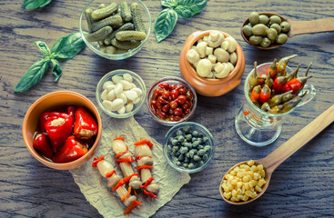 Pickled vegetables on the wooden background