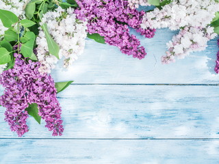 Blooming lilac flowers on the old wooden table.