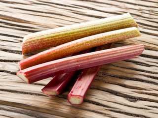 Rhubarb stalks on the wooden table.