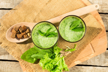 Spinach smoothie on a wooden background