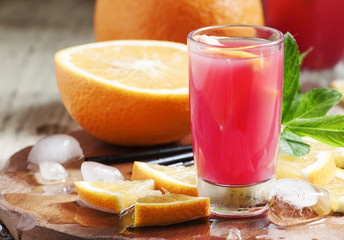 Freshly squeezed juice from red orange, selective focus