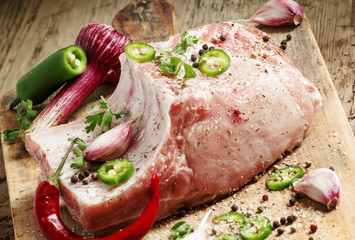 Fresh whole pork loin with spices, selective focus