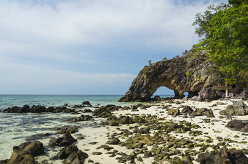 Fototapeta na wymiar Natural stone arch with beautiful beach at Kho Khai near Tarutao
