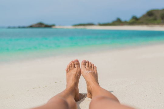 Woman's Bare Feet on the beach.