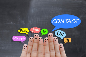 Contact us concept with happy fingers on blackboard background © adrian_ilie825