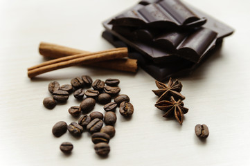 Coffee beans with cinnamon sticks and chocolate