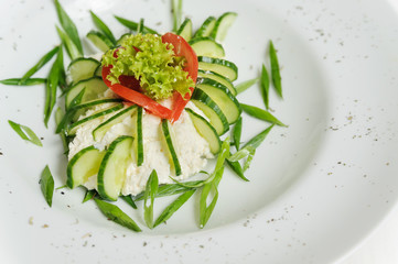 Vegetable salad with cucumbers, lettuce, tomatoes and cheese