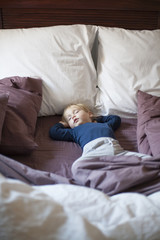 happy baby sleeping between cushions