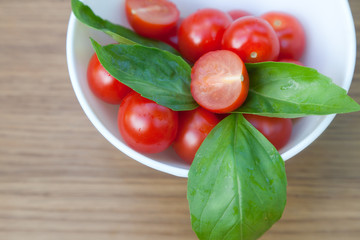 cherry tomatoes, basil and mozzarella cheese on a plate