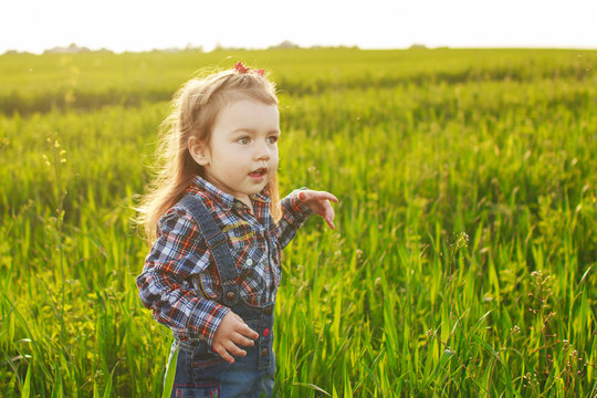 little girl walking in the field
