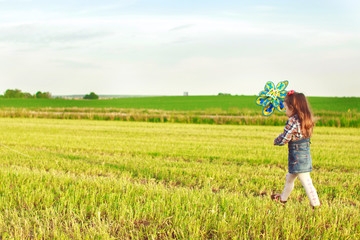 little girl walking in the field
