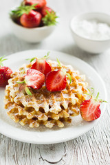 waffles with strawberries on a white plate 