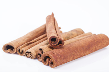group of dried cinnamon stics on white background