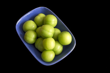 Green Plums Isolated On Black Background
