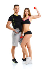 Sport couple - man and woman with dumbbells on the white