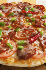 Pizza with sausage and hot peppers. 