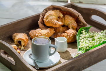 Spring breakfast with hot coffee and croissant
