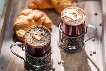 Sweet breakfast with coffee and fresh croissant