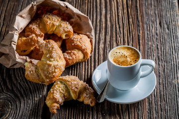 Sweet breakfast with hot coffee and fresh croissant