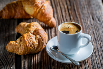 Delicious coffee and fresh croissant for breakfast