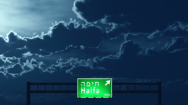 Passing under Haifa Israel Highway Road Sign at Night
  