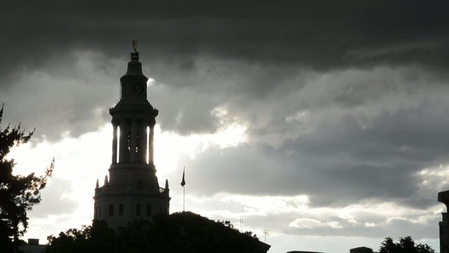 Stormy skies behind a silhouetted spire, time lapse
