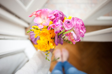 A spring gift: hand holding a bouquet of spring flowers