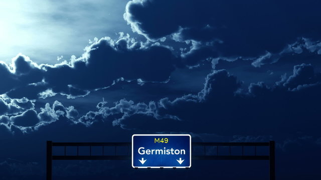 Passing under Germiston South Africa Highway Road Sign at Night
  