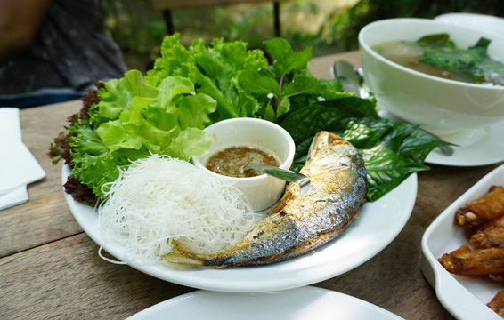 Thai style fried mackerel fish serving with fresh salad and spic