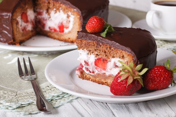 Cut cake with strawberry and chocolate close-up. Horizontal
