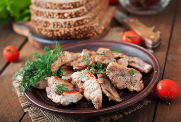 Fried pieces meat and rye bread for sandwiches