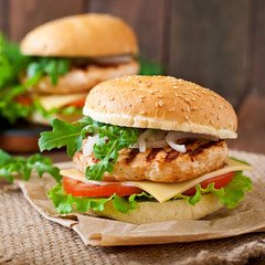 Sandwich with chicken burger, tomatoes, cheese and lettuce