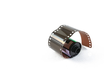 35 mm film in cartridge on a white background.
