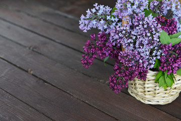 Fototapeta premium basket with branch of lilac