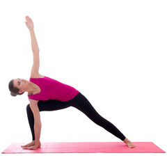 beautiful slim sporty woman standing on pink mat in yoga pose is