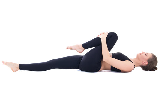 beautiful sporty woman lying and doing stretching exercise isola