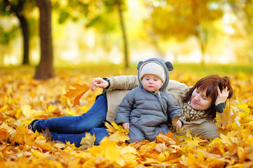 Young mother with her baby in autumn