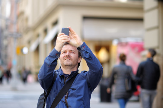 Man taking photo using his smart phone