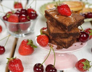 Chocolate brownies with strawberries and cherries