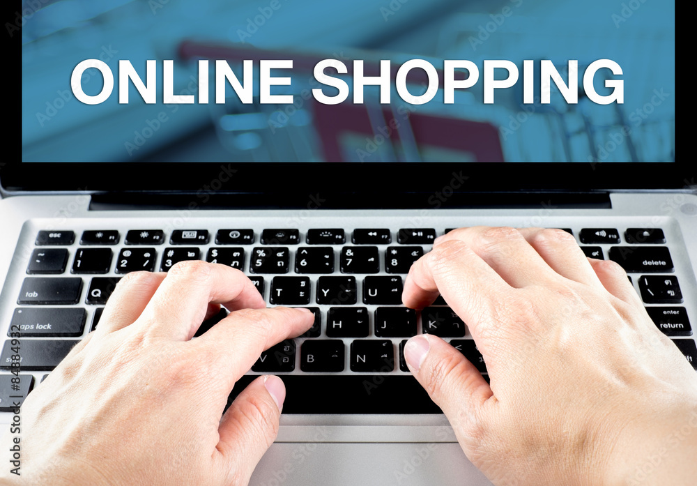 Poster hand type on laptop with online shopping word with blur backgrou