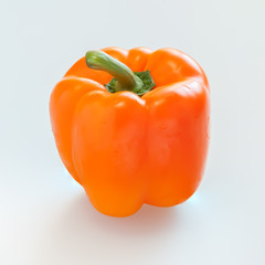 Orange capsicum or sweet pepper on white background