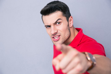 Handsome man pointing finger at camera